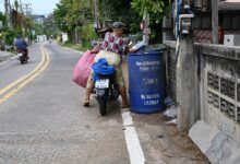 colourful recycling bins outside homes