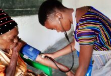 nurse checking a patient's blood pressure