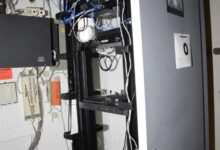 blue network cables organised in a server room
