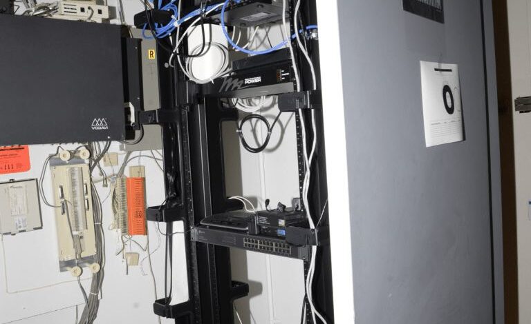 blue network cables organised in a server room
