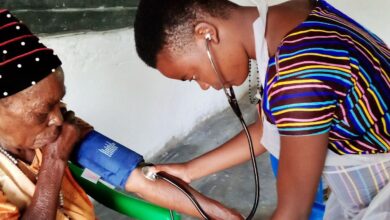 nurse checking a patient's blood pressure